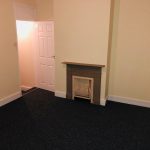 Empty living room with small fireplace